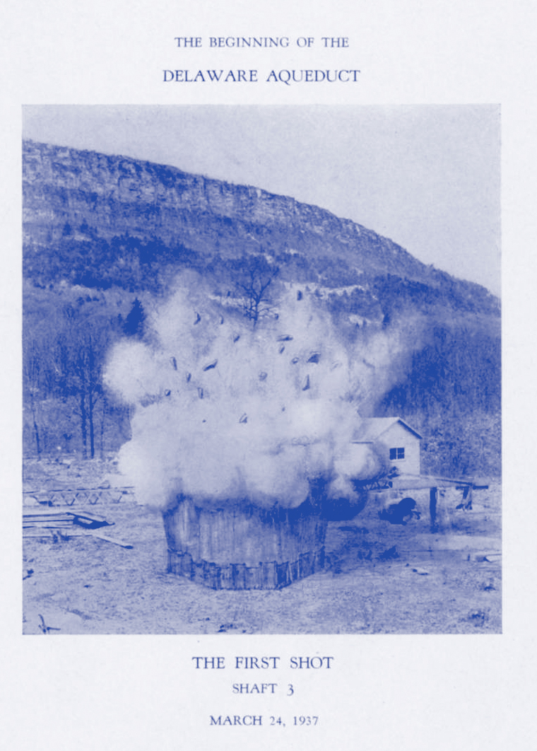 A blue toned monotone illustration with white border and text. The drawing is well or tunnel sticking out from the ground, with a plume of smoke and explosion debris flying in the air from it. There is a mountain ridge in the background.